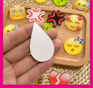Detailed view of colorful acrylic emoji charms for DIY accessories on a wood tray