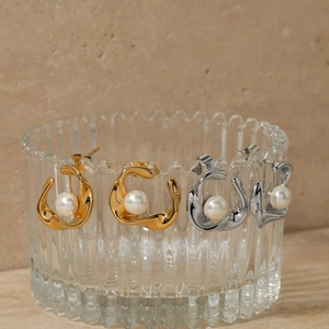 Elegant C-shape twisted pearl earrings in gold and silver finish with liquid metal design