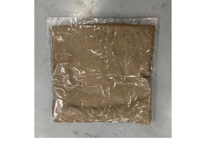 Detail of a brown plush Christmas pillowcase sealed in a transparent plastic bag