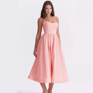 Pink backless A-line midi dress with thin straps shown in full body studio shot