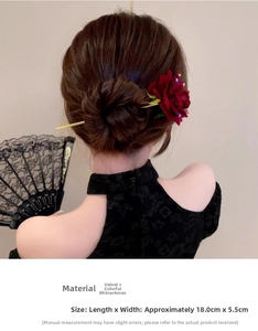 Detail of red rose hair pin with flocking texture and gold tassel on model hair