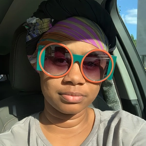 Stylish oversized round sunglasses with orange-blue frames and purple gradient lenses