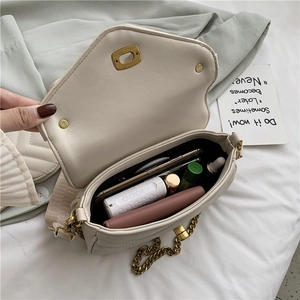 Quilted chain shoulder bag in cream white showing spacious interior with daily essentials