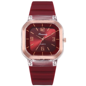 Detail of red square quartz watch featuring silicone strap and rose gold frame