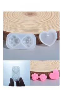 Detailed view of cat paw and heart silicone molds with translucent material for DIY resin
