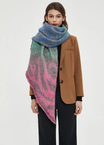 Detail showing the soft texture of a colorful leopard plaid bouclé knit scarf for women