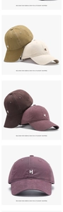 Detail view of cotton baseball caps with H letter embroidery in multiple colors