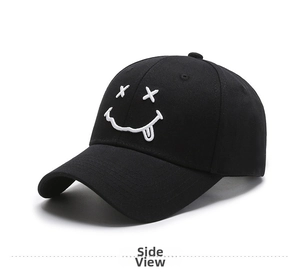 Detail of black cotton baseball cap with white embroidered smiley face on a plain background