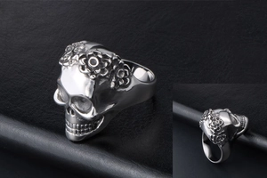 Detailed views of a men's skull ring in silver stainless steel with floral engravings