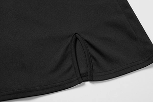 Detail of double-needle stitching and small V-slit on the hem of a black summer dress