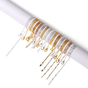 Various DIY metal chains in gold and silver colors with lobster clasps on white background