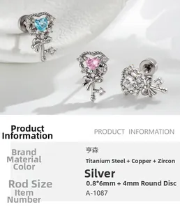 Detailed view of silver heart key stud earrings with zircon in blue, pink, and white tones