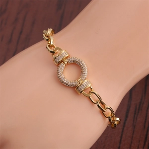 Close-up of hip hop bracelet with gold plated chain and zircon encrusted circular link