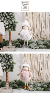 Close-up of plush Christmas girl hanging ornaments in white and pink winter themes