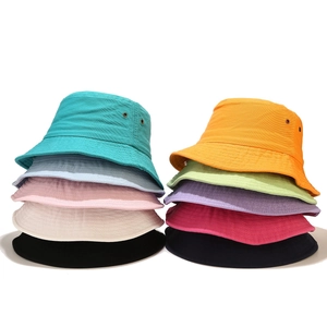 Detail showing various colors of cotton bucket hats with metal eyelets and stitched brims