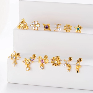 Detailed display of gold flower and star stud earrings set with sparkling zircon stones