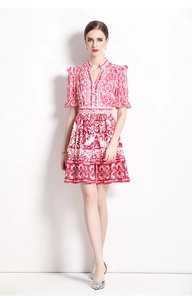 Detail of V-neck porcelain print dress with red and white baroque patterns in A-line cut