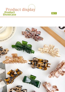 Flat lay of acetate bow claw clips in tortoise shell, marble, and floral patterns