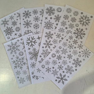 Silver glitter snowflake window stickers for Christmas decor and winter holiday glass displays