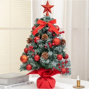 Close-up of 60cm mini desktop Christmas tree with red baubles, pine cones and red bow