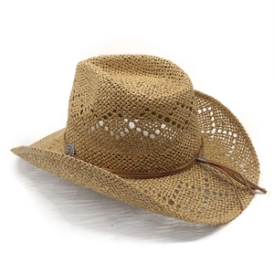 Detail of hollow straw cowboy hat with brown leather band and metal buckle ornament