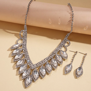Macro view of crystal rhinestone necklace set with teardrop fringe and silver plating