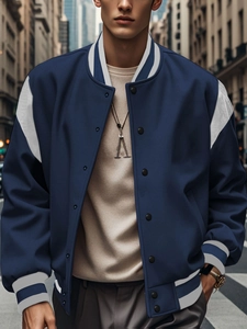 Detail of navy blue varsity jacket featuring white contrast sleeves and ribbed collar