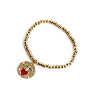 Gold beaded bracelet with red heart cross pendant and white crystals on white background