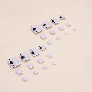 French tip toenail press-on set with black heart patterns and sparkling rhinestones