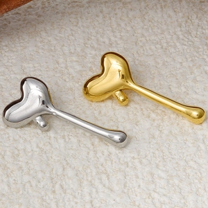 Polished 18k gold and silver heart-shaped tassel earrings in a minimalist fashion style