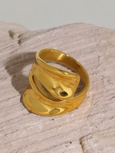 Macro view of gold 18k plated stainless steel ring with irregular wavy geometry design