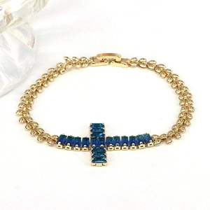 Chic gold-plated wheat chain bracelet with blue zircon cross pendant on white backdrop