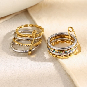 Stackable 18K gold plated stainless steel rings set with safety pin charm and cubic zirconia