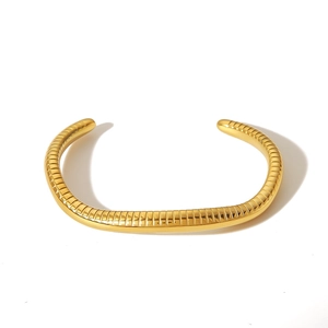 Gold-plated stainless steel cuff bracelet with snakeskin texture and geometric C-shape design