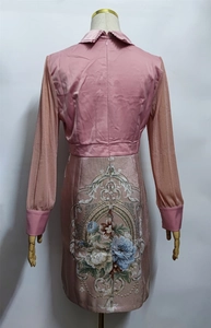 Detail of pink long sleeve dress with floral embroidery on the back and mesh sleeves