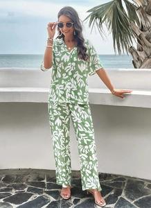Detailed view of women's two-piece set featuring green and white leaf print for summer