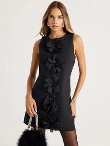Slim fit black sleeveless mini dress featuring decorative 3D floral accents on the front