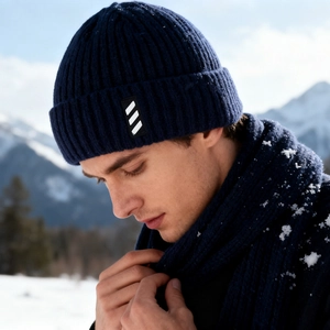 Winter navy blue knitted beanie and scarf set featuring ribbed texture in snowy outdoor scene