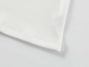 Detail shot of white modal stretch t-shirt showing double-needle hem and soft fabric texture