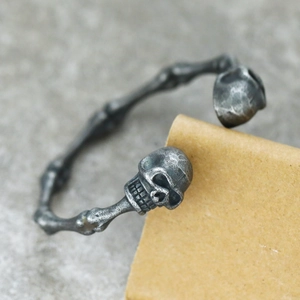 Macro shot of vintage skull ends and segmented bone texture on punk titanium steel bangle