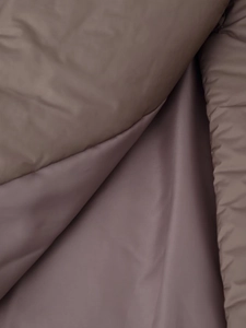 Detailed macro shot of premium dusty purple water-resistant high-density jacket fabric