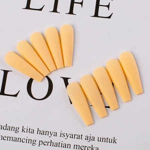 Macro detail of matte apricot coffin press-on nails neatly arranged on display card