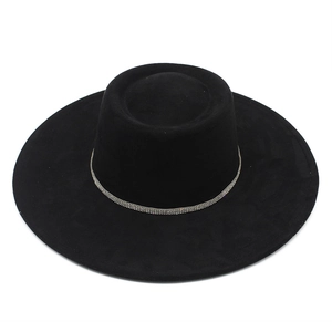 Detail of black suede boater hat with a shimmering rhinestone band and wide brim