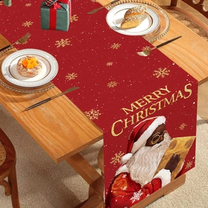 Christmas table runner with Santa Claus holding a newspaper and gold snowflake patterns