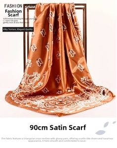 Detail of caramel paisley satin square scarf with soft sheen and silk-like drape texture