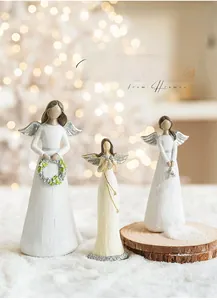 Detailed view of three resin angel figurines with wood-carved texture for Christmas decor