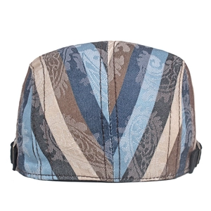 Detail of vintage paisley jacquard pattern on blue and brown adjustable beret hat