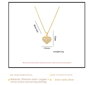 Detailed view of gold heart pendant with cubic zirconia inlay on a dainty chain