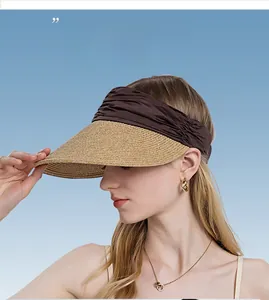 Detailed close-up of woven straw brim and brown fabric headband on sun visor