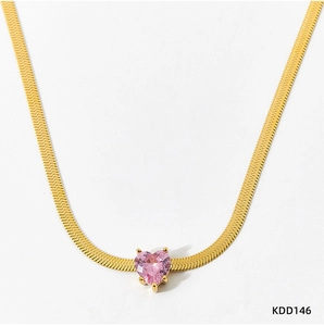 Detailed shot of pink heart-shaped zircon pendant on golden flat snake chain necklace